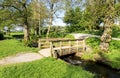 A narrow water stream with a pedestrian wooden bridge in a small public park near Ã¢â¬ÅSword in RockÃ¢â¬Â monument Royalty Free Stock Photo